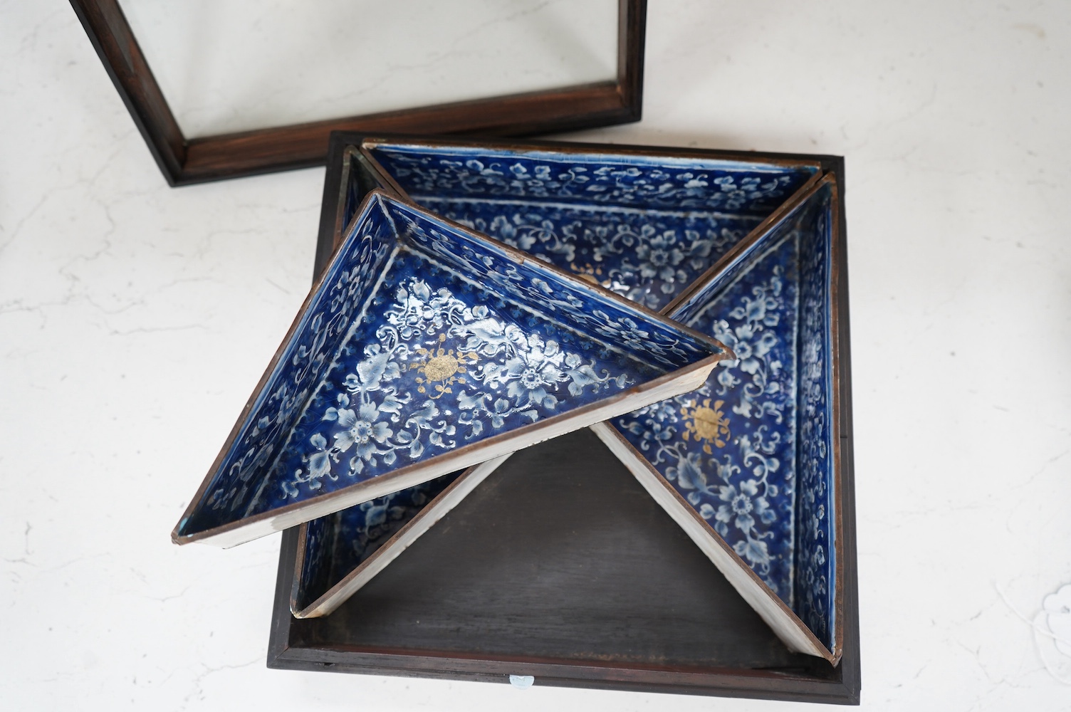 Four triangular 19th century Chinese Canton enamel sectional dishes, later boxed, 24cm wide overall. Condition - some restoration